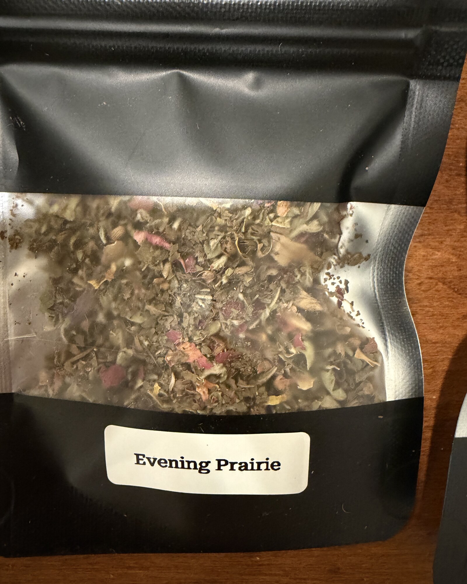 Evening Prairie — close-up of the loose herb blend through the window of its pouch